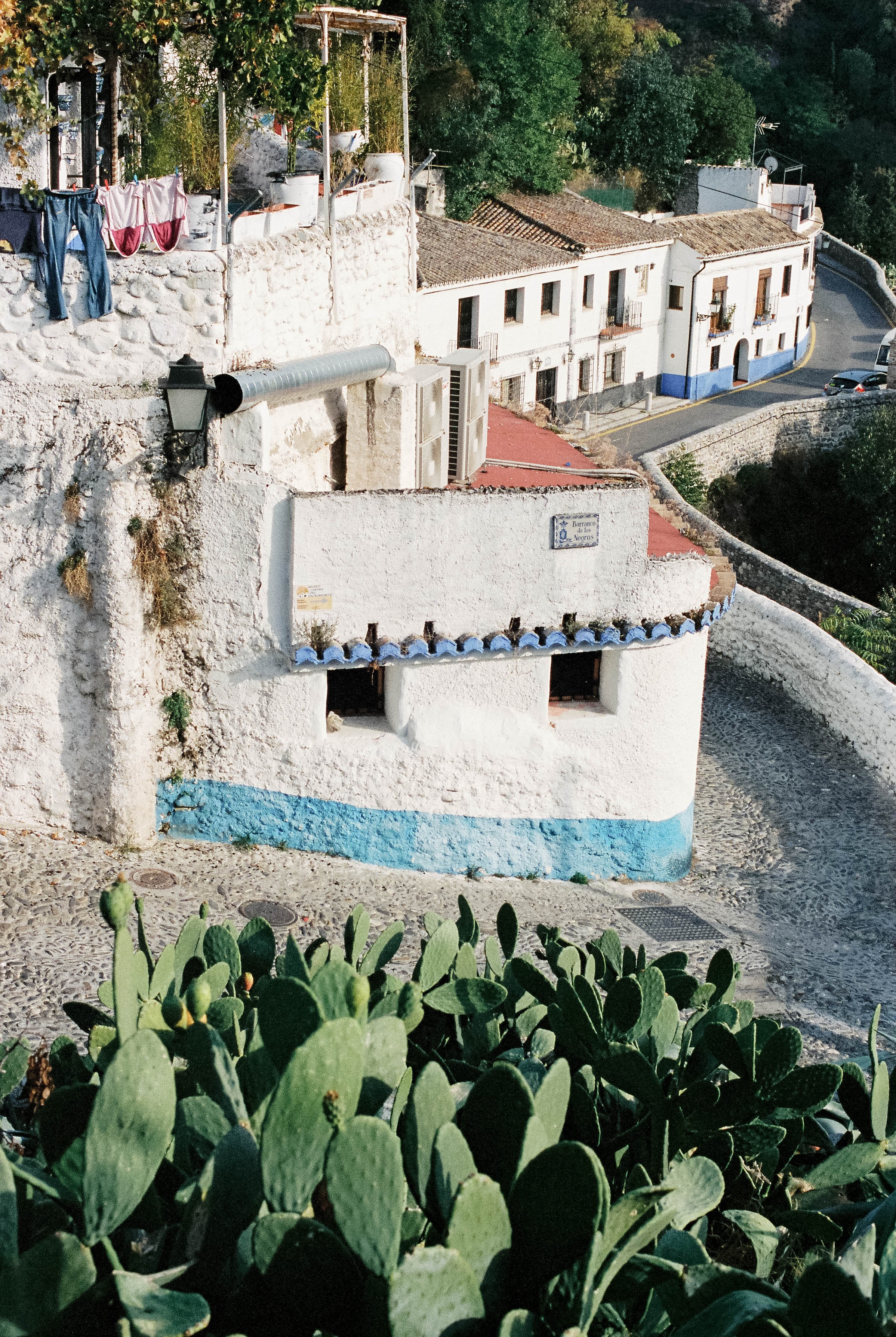 Winding street with white buildings in Granada